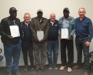 a group of successful railway infrastructure worker trainees with their certificates